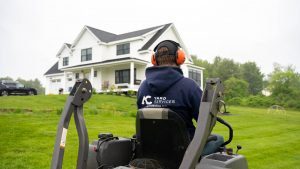 An ACYS Employee mowing a client's lawn